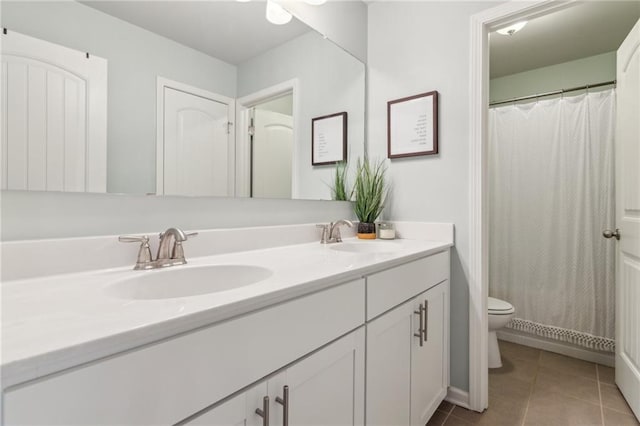 bathroom featuring vanity, tile patterned floors, and toilet