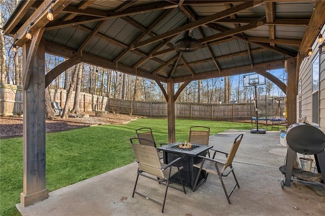 view of patio / terrace with a gazebo, a trampoline, grilling area, and an outdoor fire pit