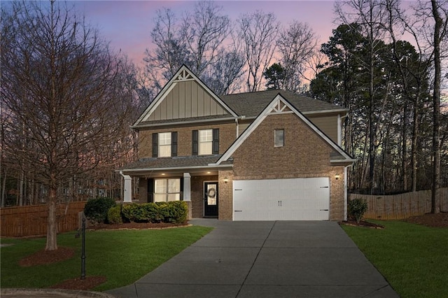 view of front facade featuring a garage and a lawn