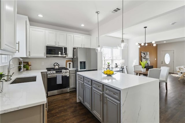 kitchen featuring recessed lighting, gray cabinetry, a sink, visible vents, and appliances with stainless steel finishes