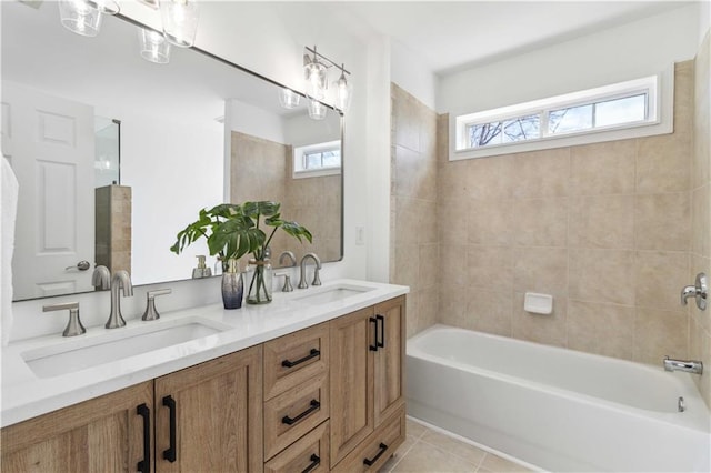 bathroom with tile patterned flooring, a sink, and a wealth of natural light