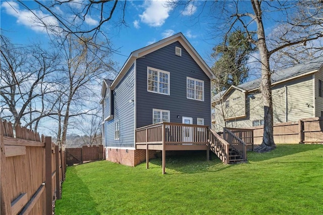 rear view of property with a deck, a yard, and a fenced backyard