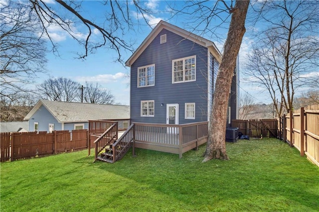 rear view of property with a deck, central AC, a lawn, and a fenced backyard