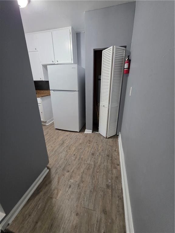 2802 3rd Ave SW, Atlanta, GA 30315 - kitchen with freestanding refrigerator, light wood-style flooring, and white cabinetry
