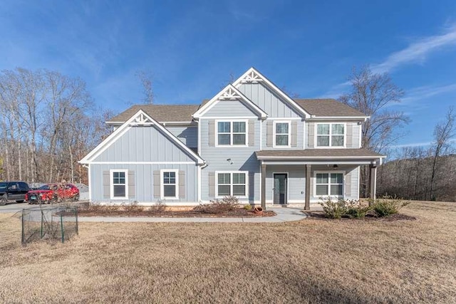 craftsman inspired home with a front yard and covered porch