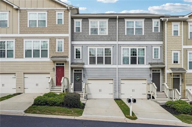 townhome / multi-family property with driveway and an attached garage