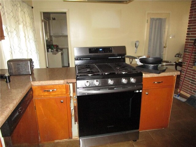 kitchen with tile patterned floors, dishwasher, and gas stove