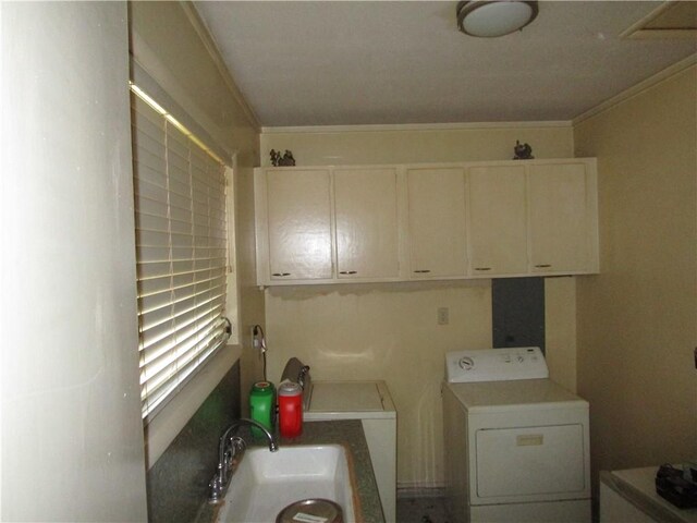 laundry room featuring washer / clothes dryer, sink, cabinets, and ornamental molding