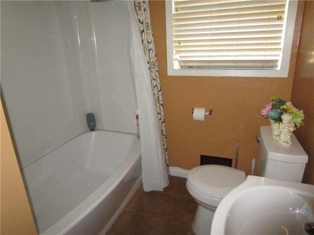 full bathroom with shower / bath combo with shower curtain, toilet, tile patterned flooring, and sink