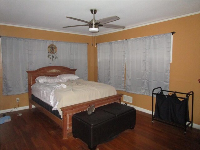 bedroom featuring ceiling fan, dark hardwood / wood-style flooring, and crown molding