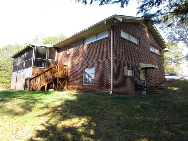 rear view of house with a sunroom and a lawn