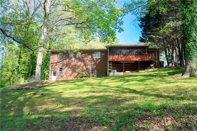 991 Lakemont Dr, Gainesville, GA 30501 - rear view of house with a sunroom, a lawn, and brick siding