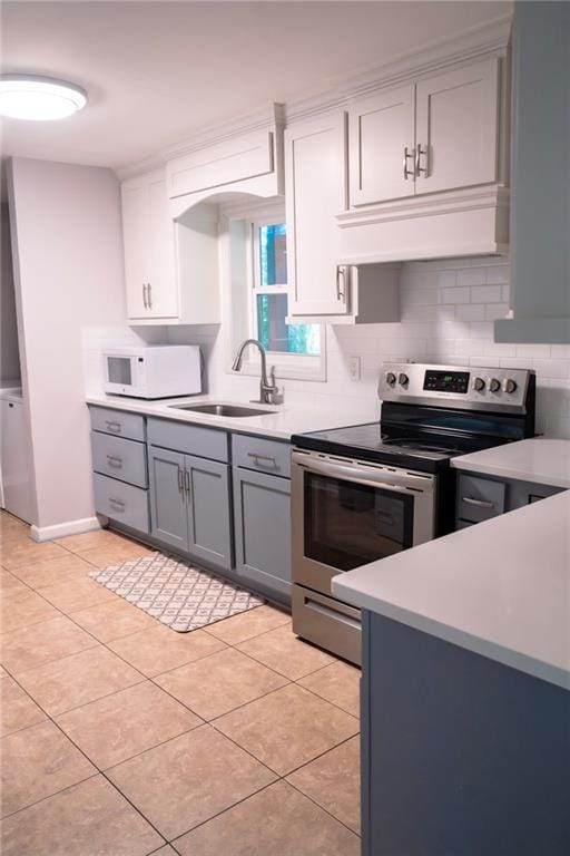 991 Lakemont Dr, Gainesville, GA 30501 - kitchen with stainless steel electric range, a sink, white microwave, and light countertops