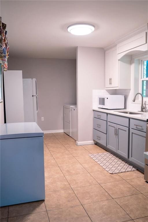 991 Lakemont Dr, Gainesville, GA 30501 - kitchen with washer and dryer, white appliances, a sink, gray cabinetry, and light tile patterned floors