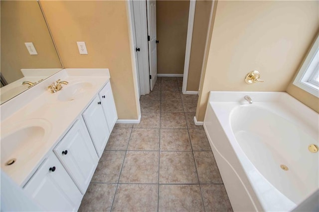 full bath with a sink, tile patterned flooring, double vanity, baseboards, and a bath