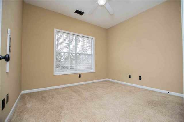 carpeted empty room featuring a ceiling fan, baseboards, and visible vents