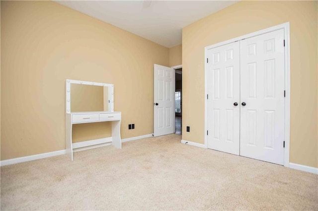 unfurnished bedroom featuring a closet, baseboards, and carpet