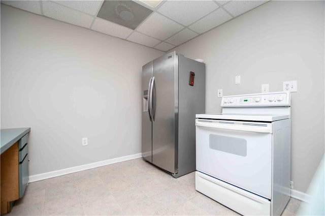 kitchen with white range with electric stovetop, a drop ceiling, baseboards, and stainless steel refrigerator with ice dispenser