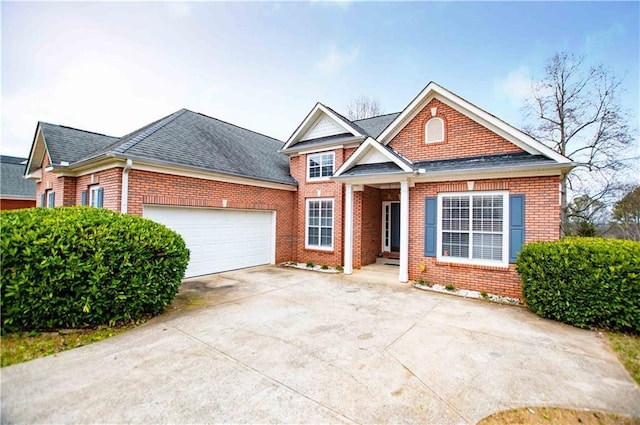 view of front of house with brick siding, concrete driveway, a garage, and a shingled roof