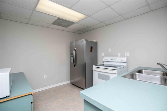 kitchen featuring white electric stove, a drop ceiling, stainless steel refrigerator with ice dispenser, and a sink