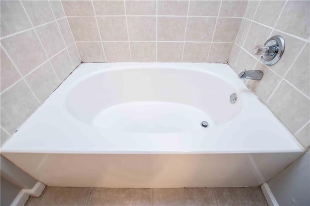 bathroom featuring tile patterned floors and a bathtub