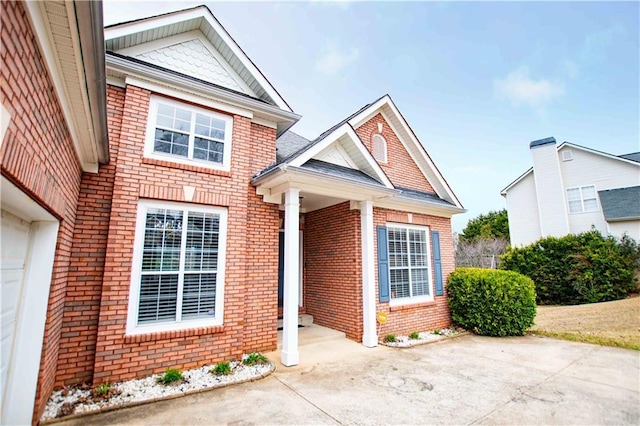 doorway to property with brick siding