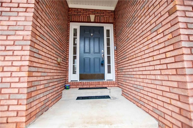 entrance to property with brick siding