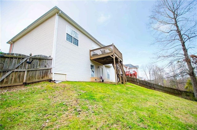 back of house with stairway, a deck, a yard, and fence private yard