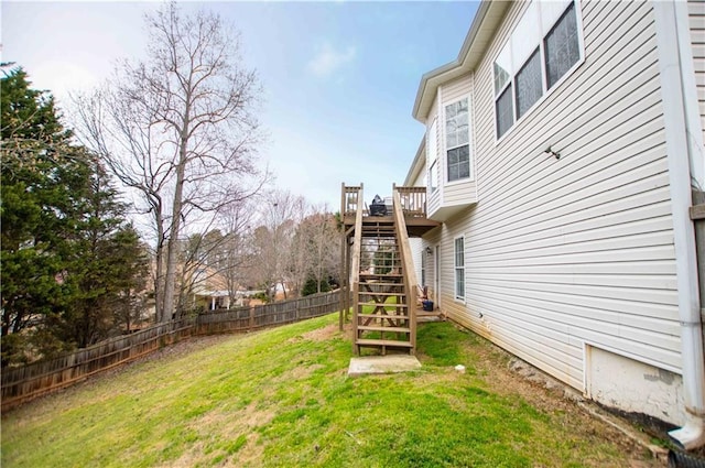 view of yard featuring stairs, a deck, and fence