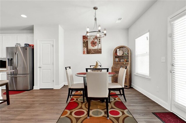 dining room featuring a chandelier, dark wood-style floors, baseboards, and recessed lighting
