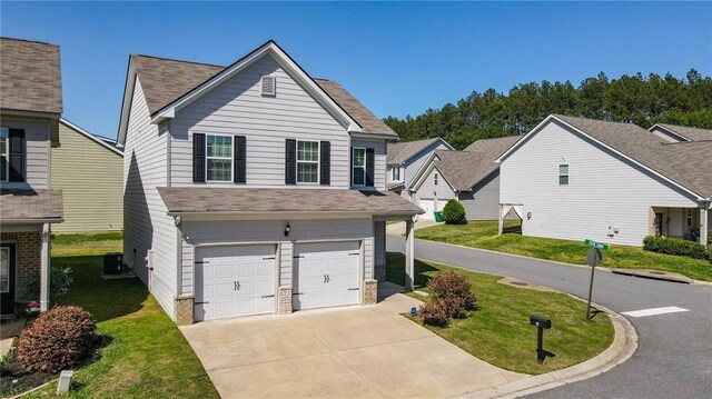 traditional-style house featuring a garage, a front yard, driveway, and a shingled roof