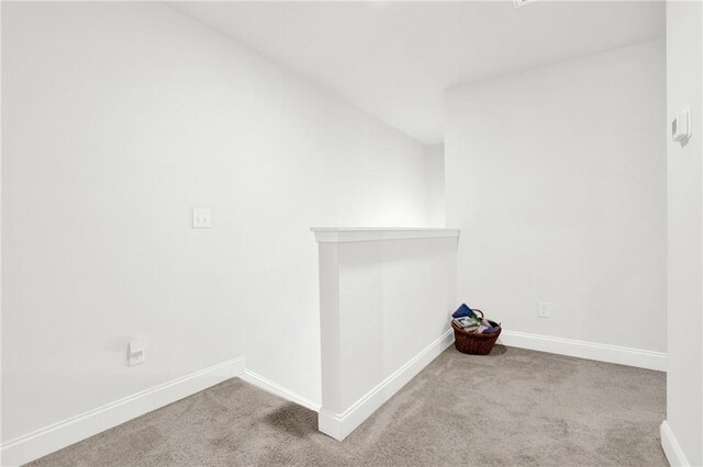 carpeted spare room with baseboards