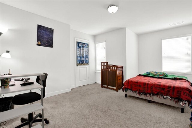 carpeted bedroom with baseboards