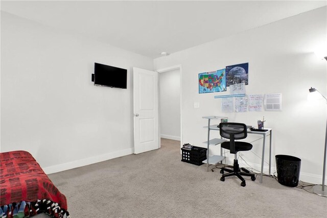 carpeted office space featuring baseboards