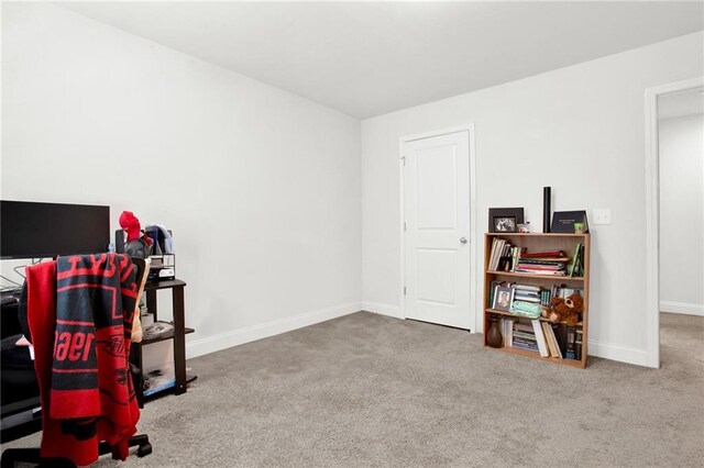 home office featuring carpet flooring and baseboards