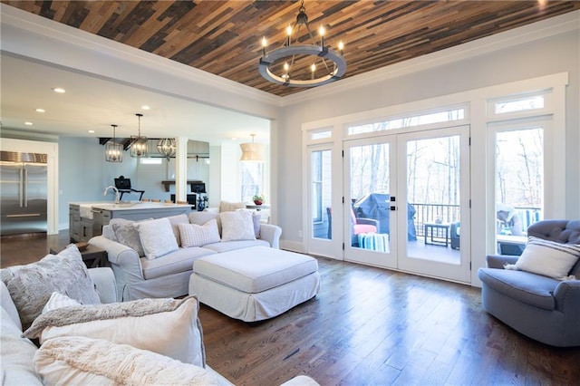 living room with dark wood-type flooring, wooden ceiling, a notable chandelier, and french doors