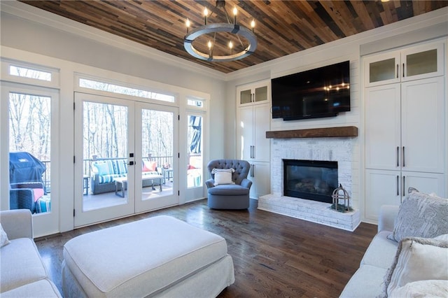 living area with a glass covered fireplace, wooden ceiling, dark wood-style floors, crown molding, and french doors