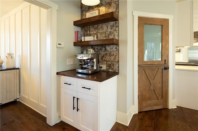 bar featuring dark wood-type flooring