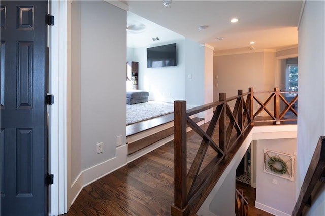 corridor with dark wood-style flooring, recessed lighting, visible vents, an upstairs landing, and baseboards