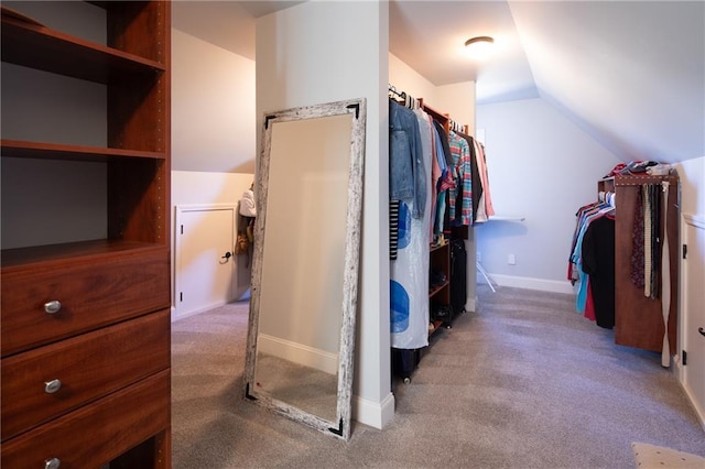 walk in closet featuring carpet floors and lofted ceiling