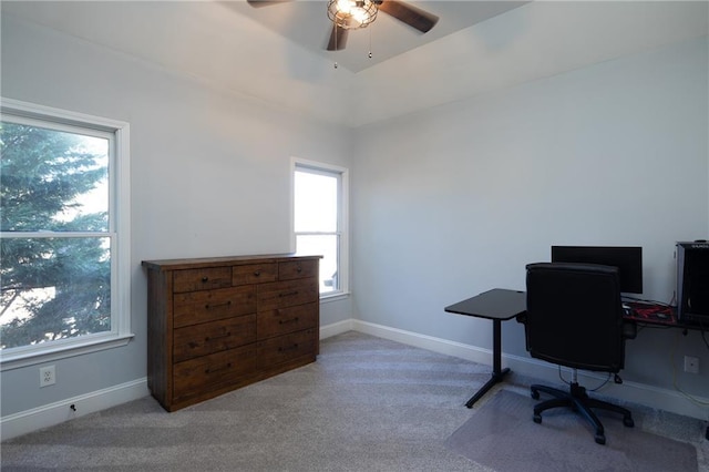 office space featuring carpet floors, ceiling fan, and baseboards