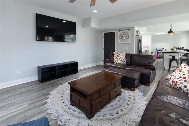 living room with ceiling fan, baseboards, wood finished floors, and recessed lighting