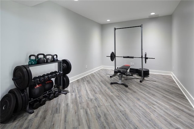 exercise room with light wood-style floors, baseboards, and recessed lighting