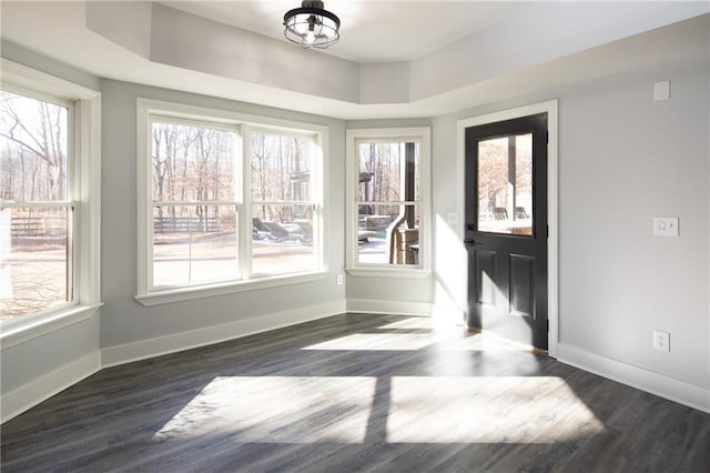 interior space featuring an inviting chandelier, plenty of natural light, baseboards, and dark wood-style flooring