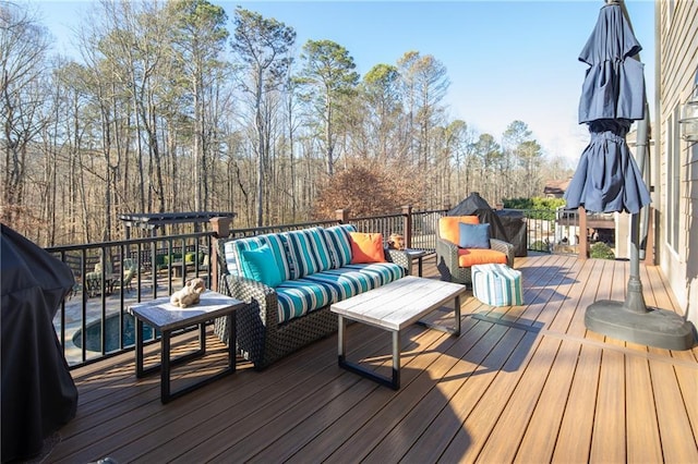 deck with an outdoor hangout area and area for grilling