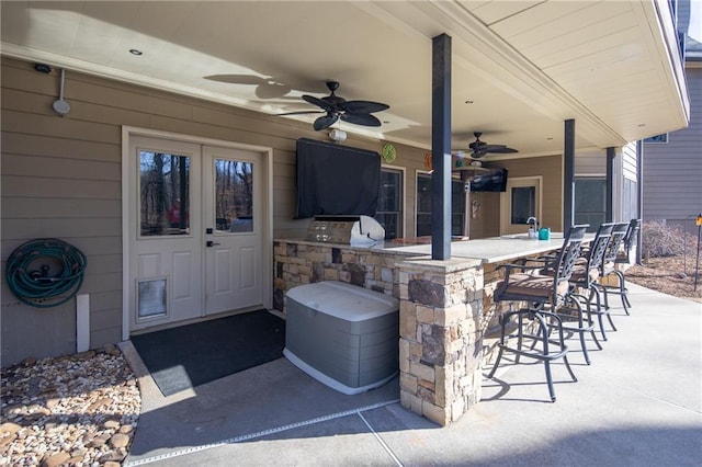 view of patio / terrace featuring a grill, outdoor dry bar, a sink, and area for grilling