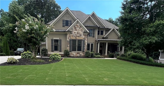 craftsman inspired home featuring stone siding and a front yard