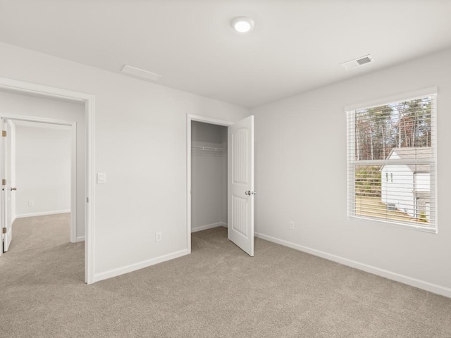 unfurnished bedroom featuring baseboards and light colored carpet