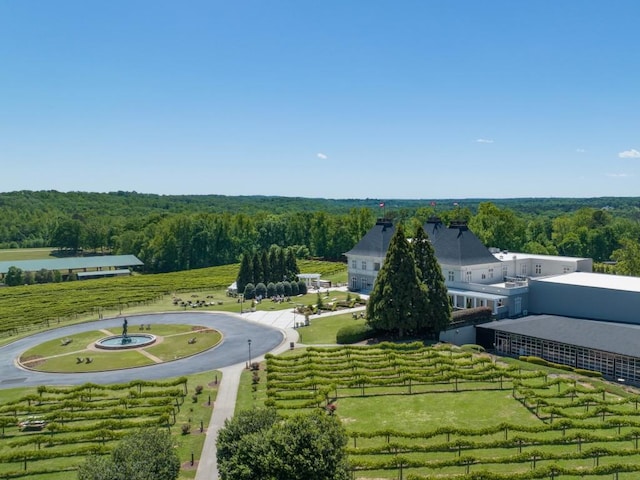 drone / aerial view featuring a wooded view