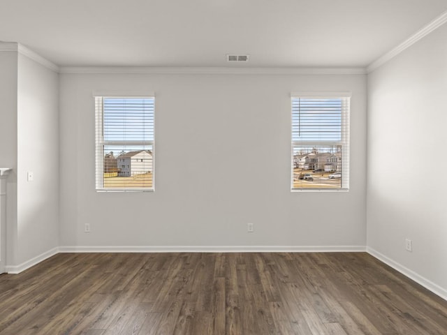 empty room with a healthy amount of sunlight, baseboards, visible vents, and dark wood finished floors